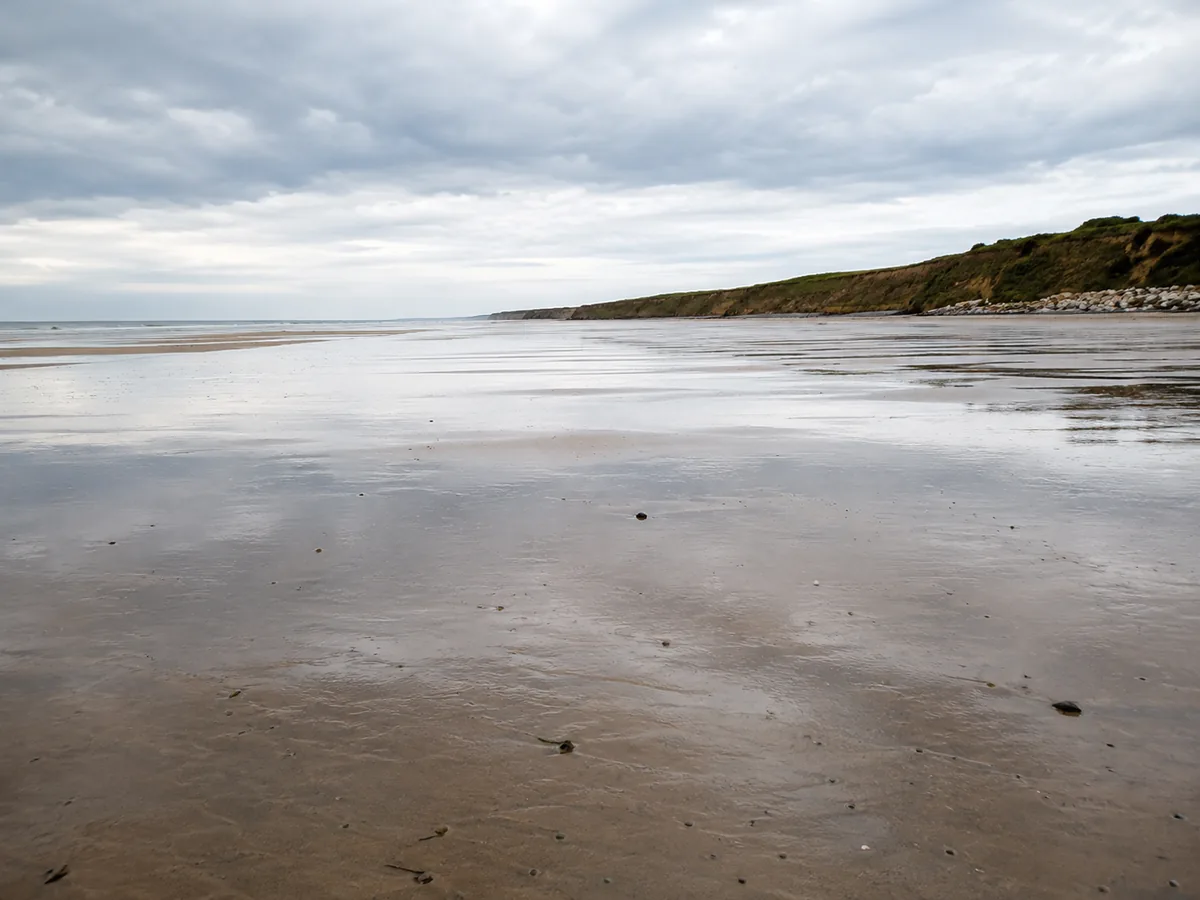 Omaha Beach at low tide below the bluffs at Saint-Laurent-sur-Mer
